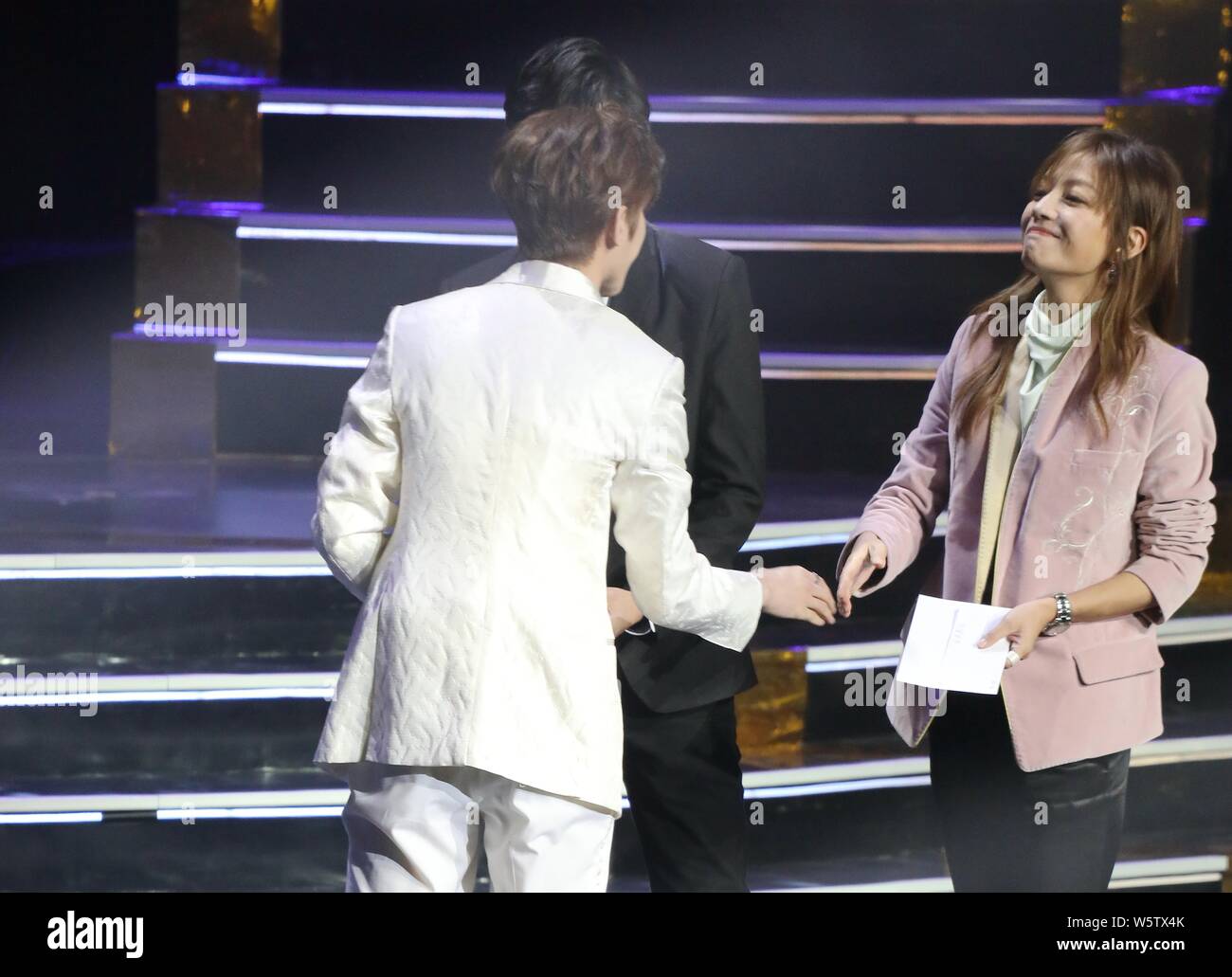 Chinese actress Zhao Wei, right, presents the award to Singer and ...