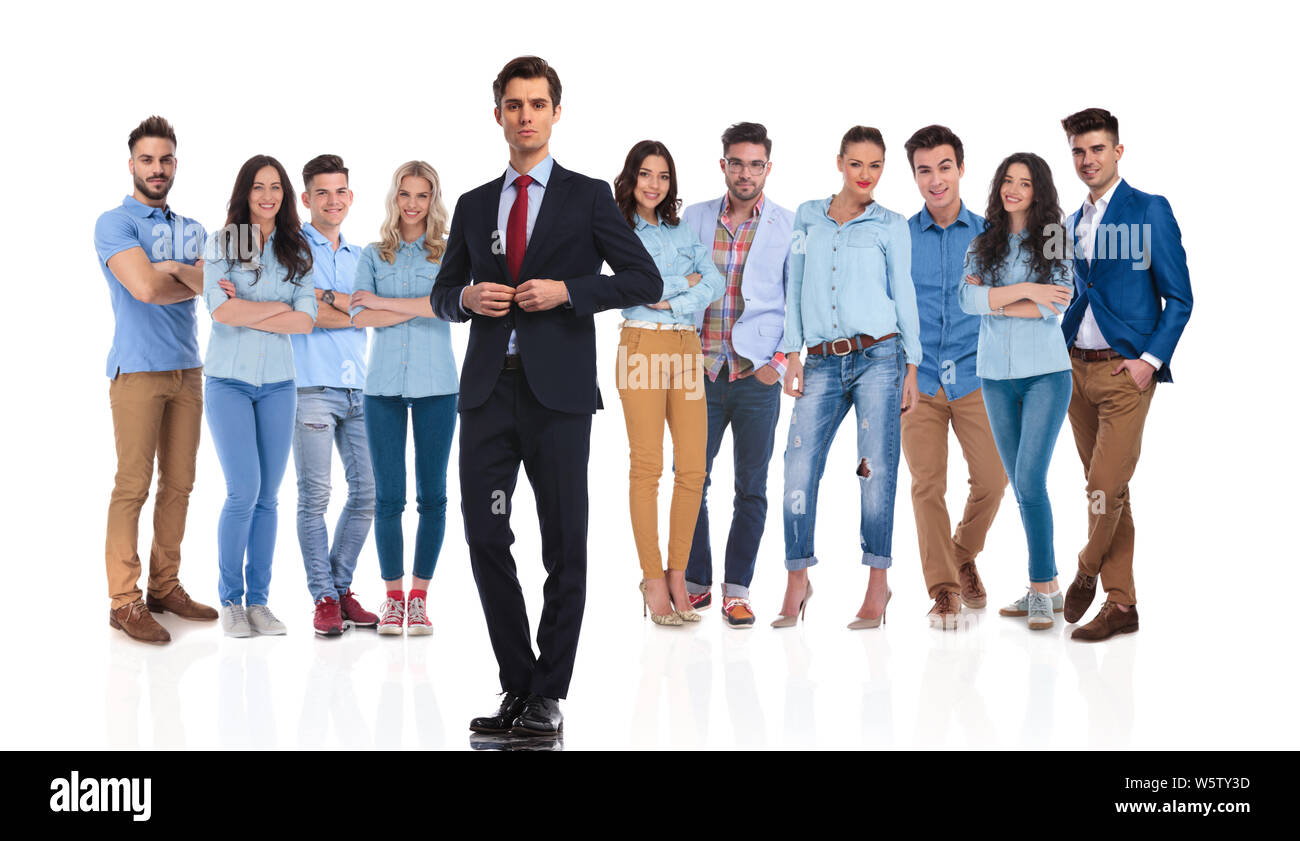 businessman group leader buttoning suit jacket in front of his casual