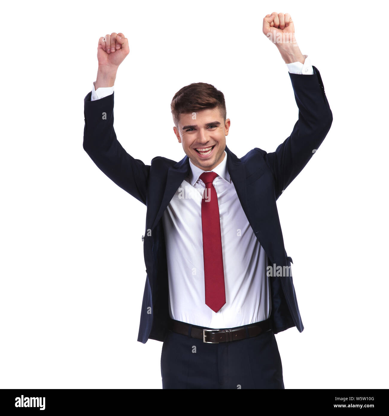 portrait of laughing businessman celebrating success with fists in the