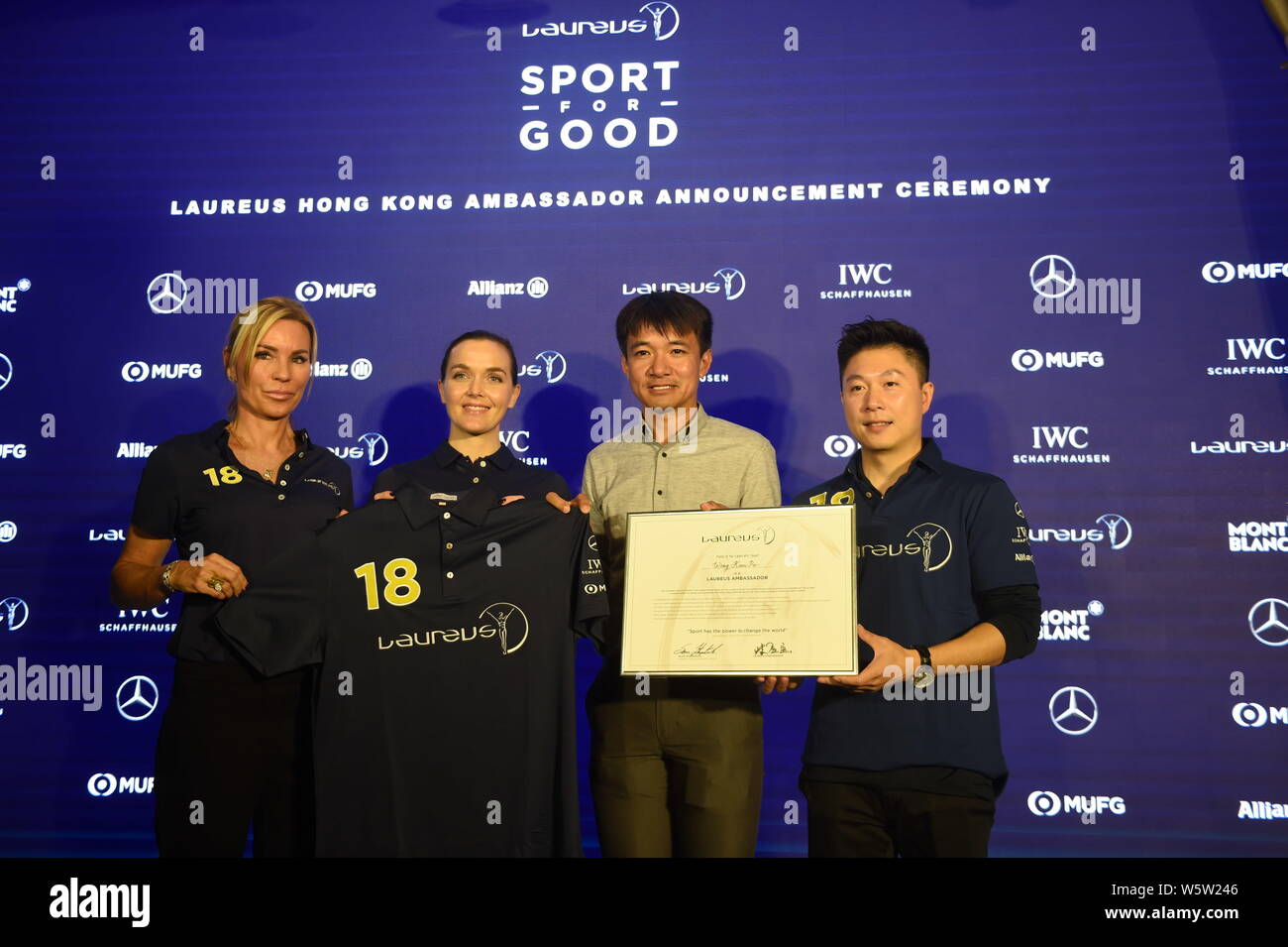 Laureus Ambassador Annabelle Bond, Laureus Ambassador Victoria Pendleton, and Laureus World Sports Academy member Li Xiaopeng present a certificate an Stock Photo
