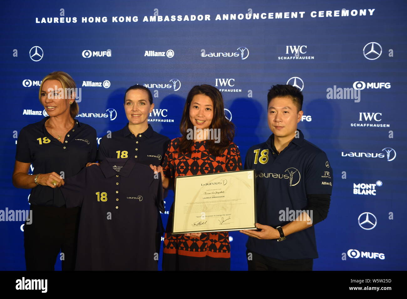 Laureus Ambassador Annabelle Bond, Laureus Ambassador Victoria Pendleton, and Laureus World Sports Academy member Li Xiaopeng present a certificate an Stock Photo