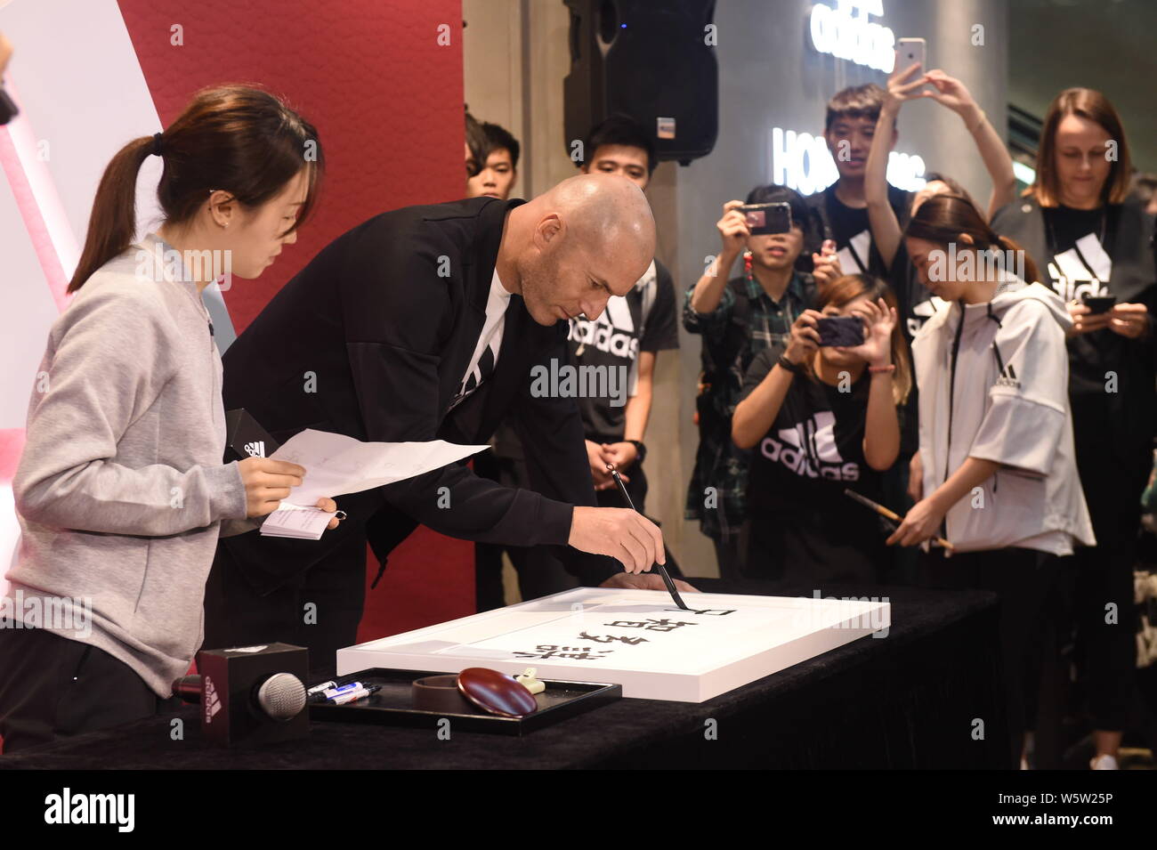 French football superstar and coach Zinedine Zidane shows his Chinese  calligraphy at a fan meeting event at a flagship store of Adidas in Hong  Kong, 1 Stock Photo - Alamy