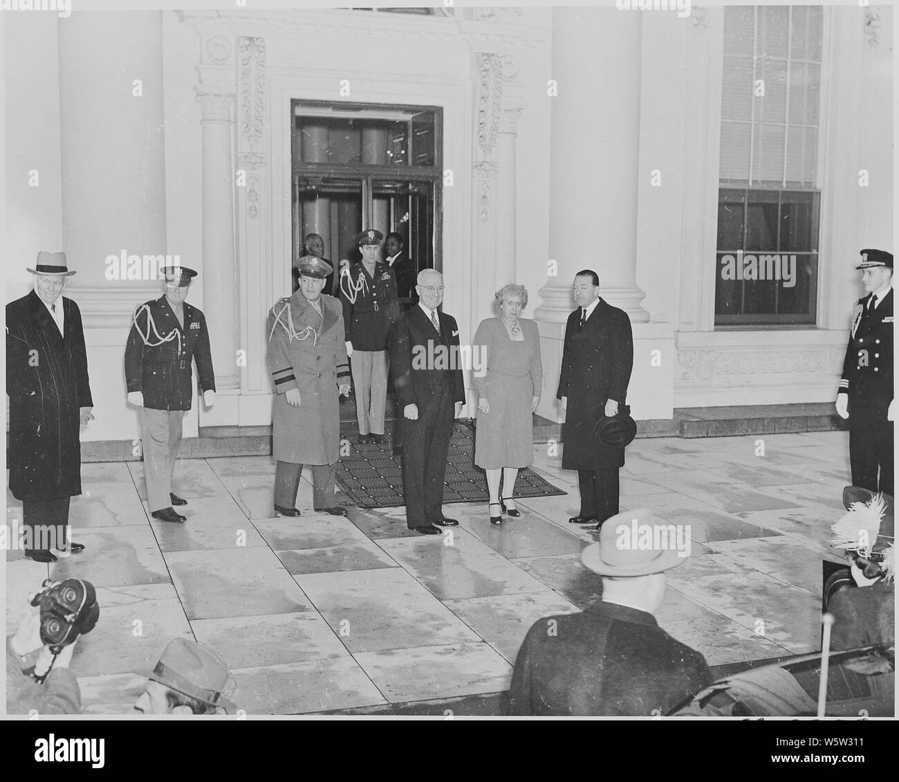 Photograph of President Truman and Mrs. Truman standing outside the White House. awaiting the arrival of Field Marshal Harold Alexander (the Governor General of Canada) and Lady Alexander. Stock Photo