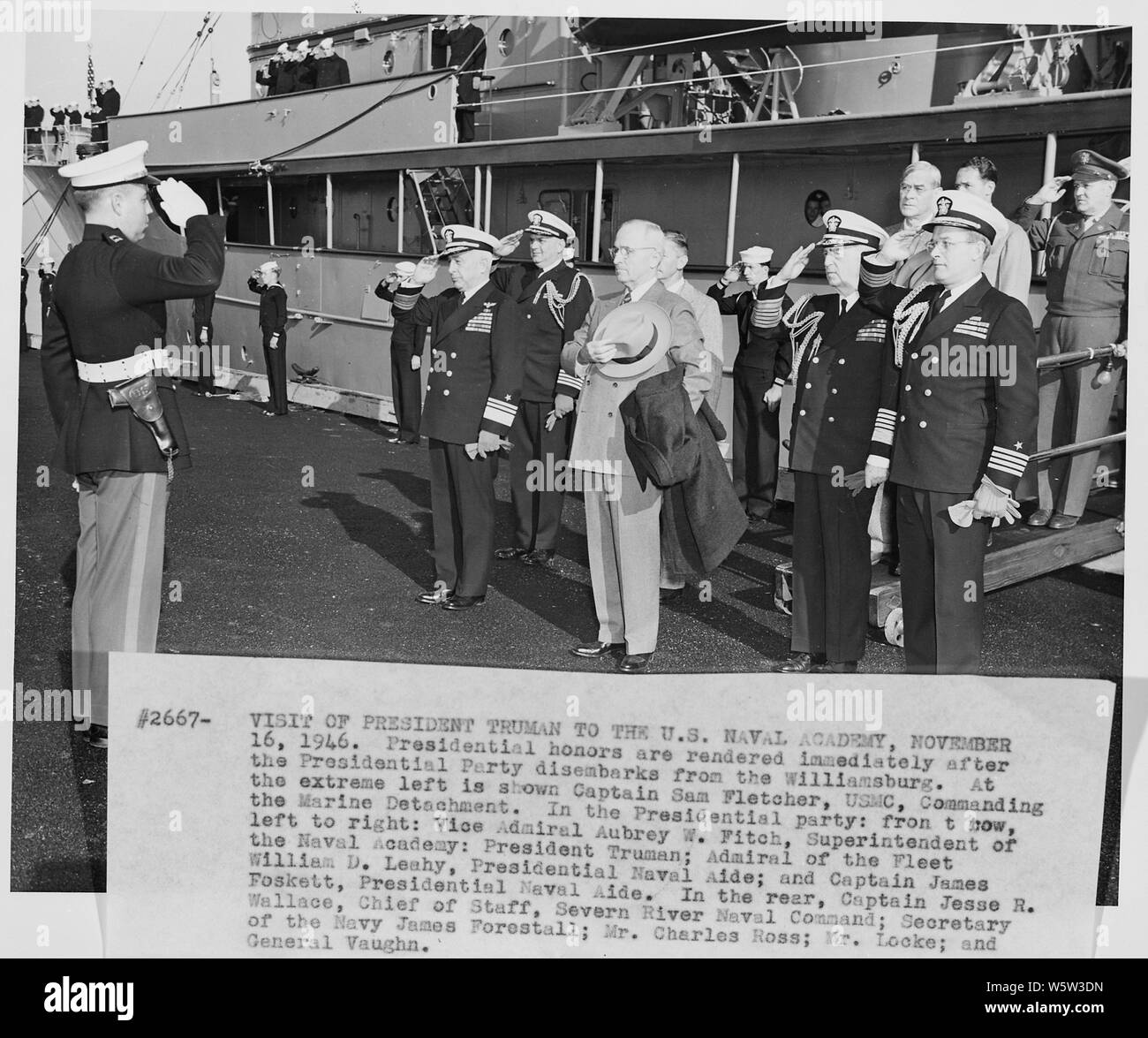 Photograph of President Truman and his party receiving honors as they disembark from the President's yacht, the U.S.S. WILLIAMSBURG, at the U.S. Naval Academy: (left to right) Captain Sam Fletcher, USMC; Vice Admiral Aubrey Fitch, Superintendent of the Naval Academy; Captain Jesse Wallace, Chief of Staff, Severn River Naval Command; the President; Secretary of the Navy James Forrestal (partially obscured) Fleet Admiral William Leahy; Press Secretary Charles Ross; Captain James Foskett, Naval Aide to the President; White House aide Edwin Locke, Jr. (partially obscured); General Harry Vaughan, M Stock Photo