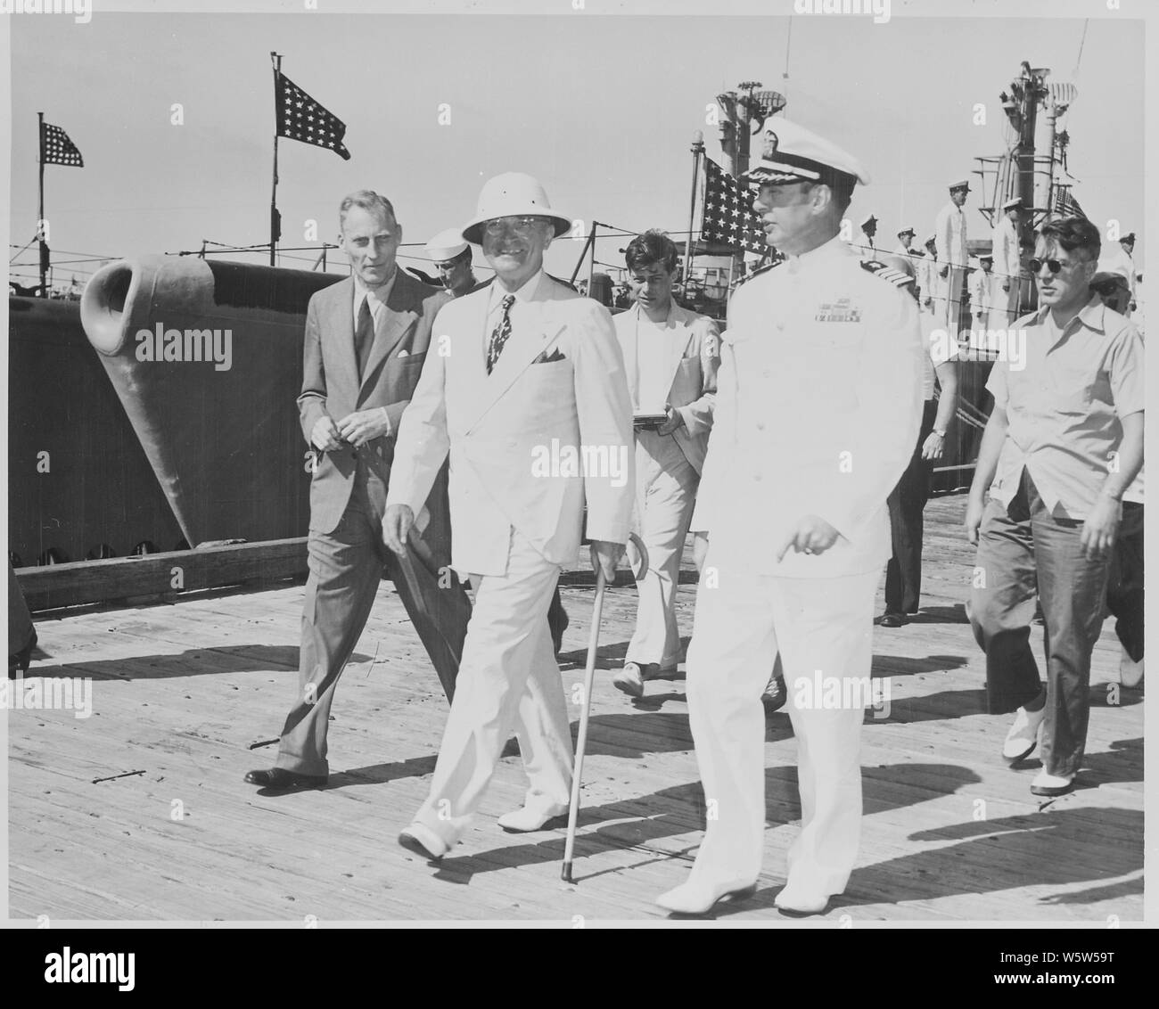 Photograph of President Truman during a tour of the submarine base at Key West, Florida, with Assistant Press Secretary Eben Ayers (left) and Captain Robert Dennison, Naval Aide to the President. Stock Photo