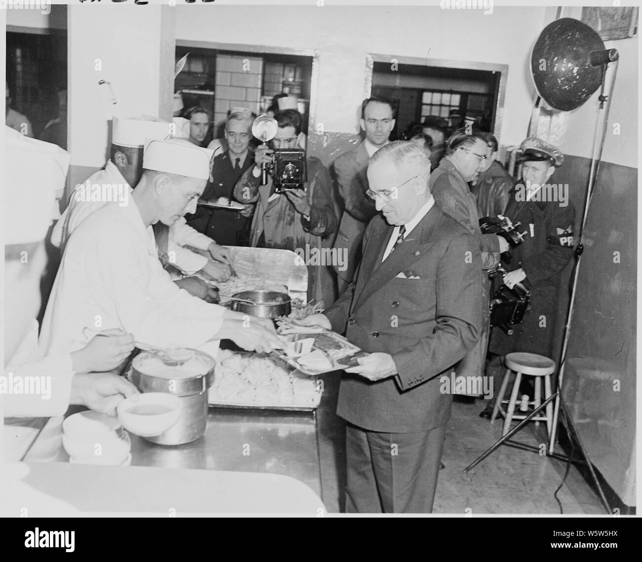 Photograph of President Truman holding his tray in the chow line at the mess hall, during his visit to Aberdeen Proving Ground in Maryland. Stock Photo