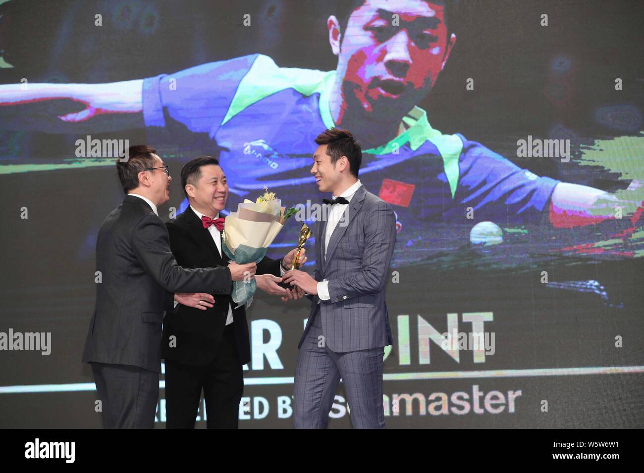 Chinese table tennis player Xu Xin, right, receives his 'Star Point Award' trophy during the Star Awards of the 2018 International Table Tennis Federa Stock Photo