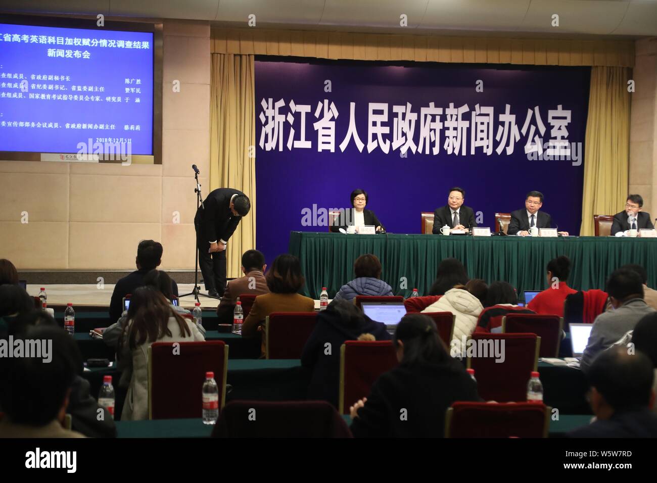 Chen Genfang, left, Director of Zhejiang Provincial Department of Education, apologizes at a press conference after an investigation following public Stock Photo