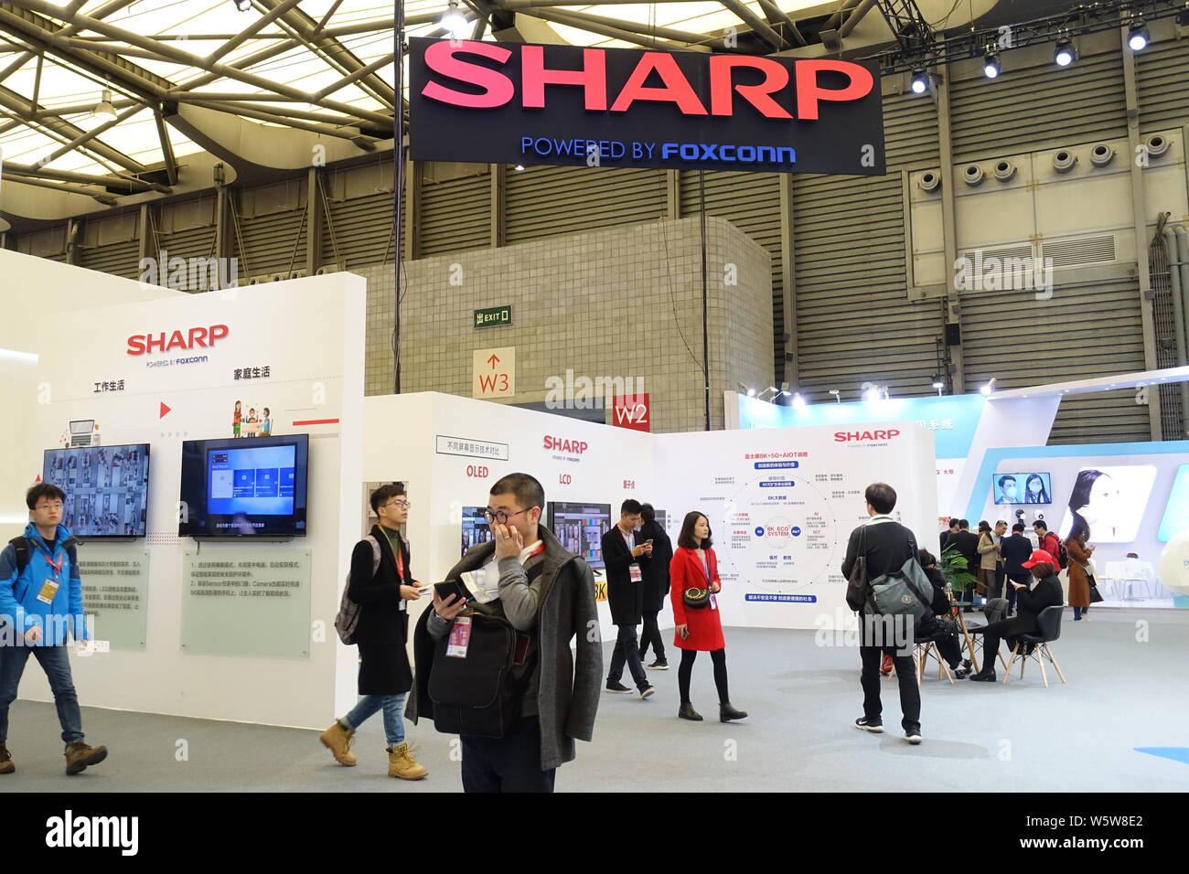 FILE--People visit the stand of Sharp during an expo in Shanghai ...