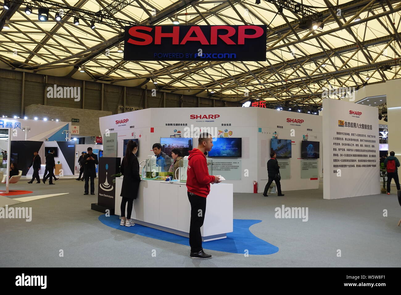 --FILE--People visit the stand of Sharp during an expo in Shanghai ...