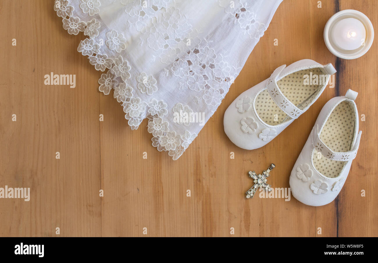 Baptism booties vintage crhistening dress candel and crystal pendant on rustic wooden background top view photo with text space Stock Photo Alamy