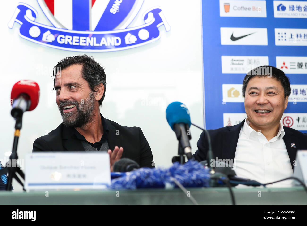 Spanish football manager Quique Sanchez Flores, left, the new head coach of Shanghai Greenland Shenhua FC, attends a press conference in Shanghai, Chi Stock Photo