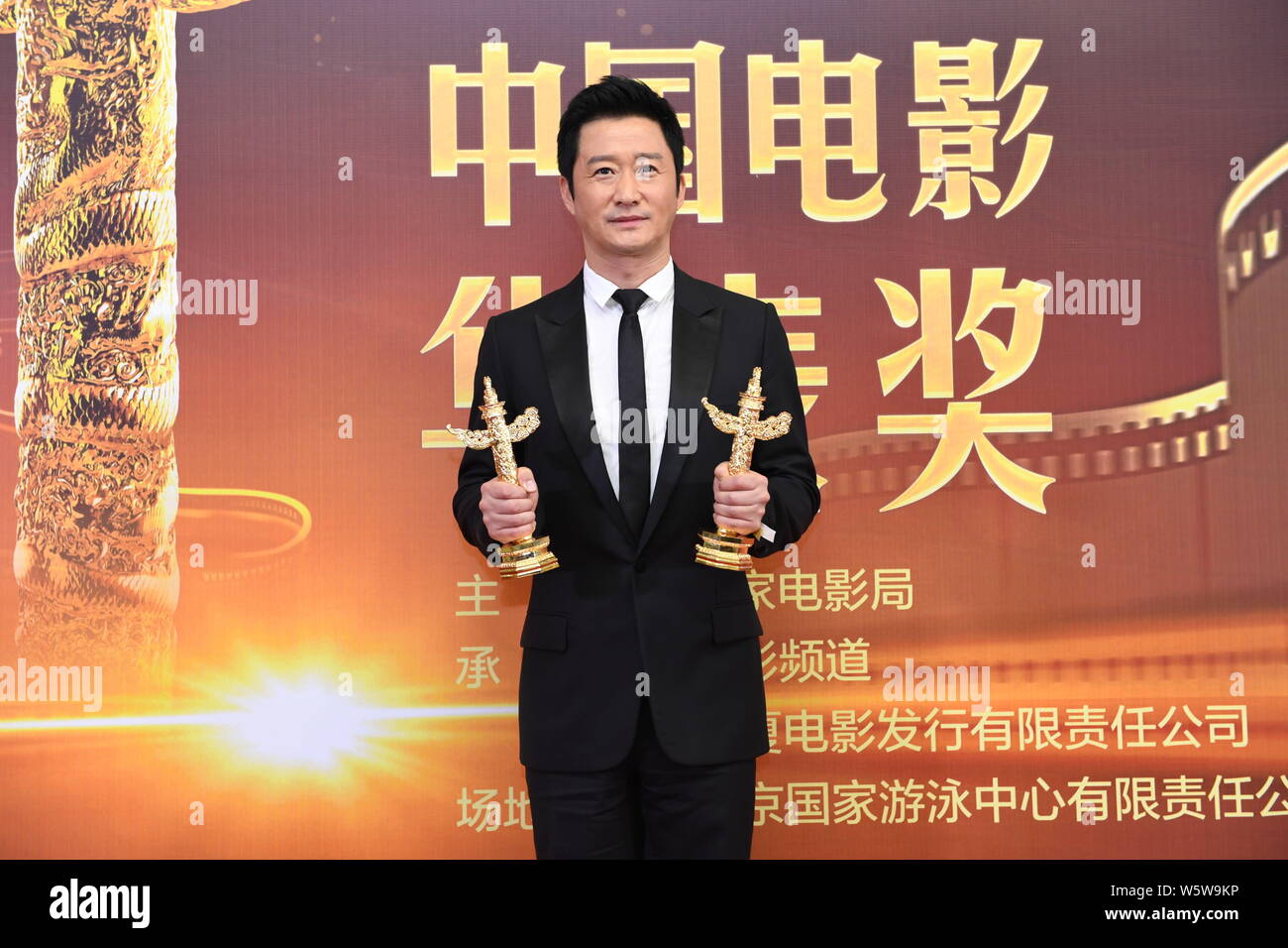 chinese-actor-and-director-wu-jing-poses-with-his-trophy-after-winning
