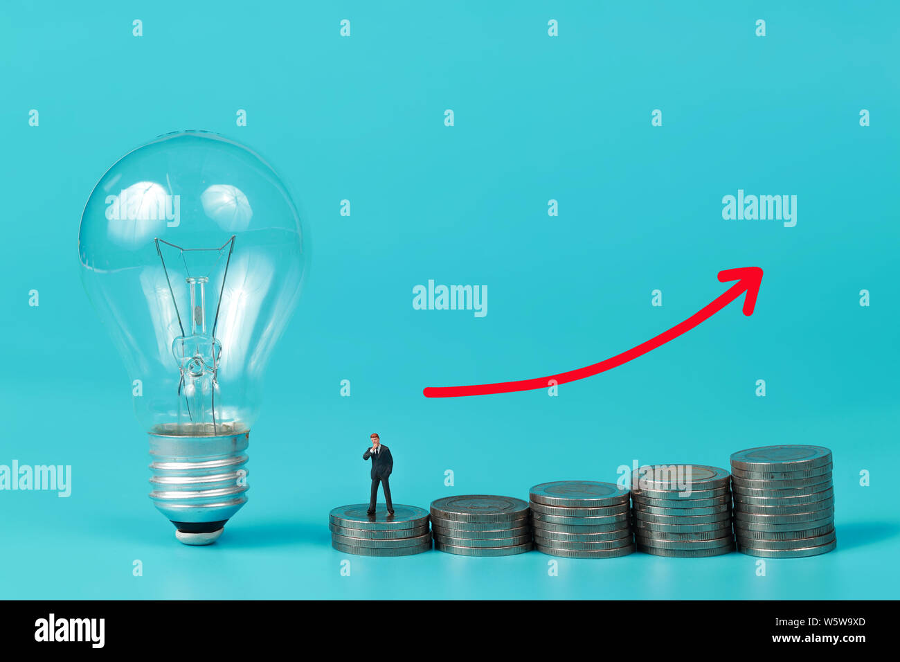 Miniature people: businessman standing on coin stacking podium with ...