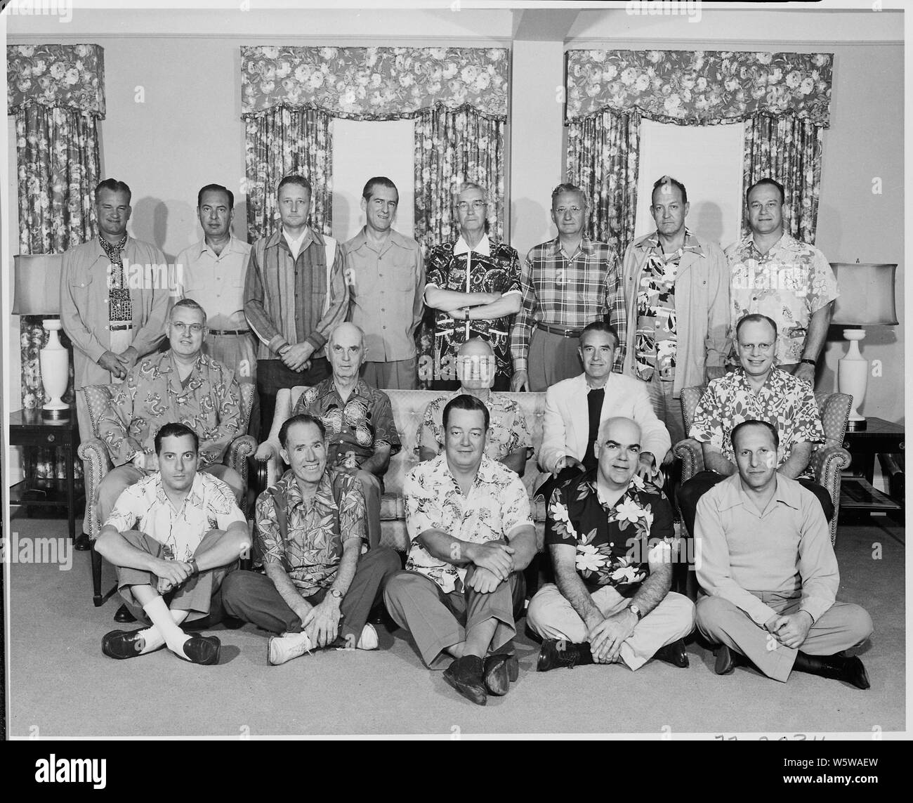 Photograph of President Truman with members of his official party (many attired in Hawaiian shirts), on vacation in Key West, Florida: (front row, left to right) Richard Neustadt, Cornelius Mara, Joseph Feeney, Philleo Nash, Irving Perlmeter; (second row, left to right) John R. Steelman, William Leahy, President Truman, W. Averell Harriman, Charles Murphy; (third row, left to right) Robert Landry, Robert Dennison, Stanley Woodward, Matthew Connelly, William Hassett, Joseph Short, Harry Vaughan, and Wallace Graham. Stock Photo