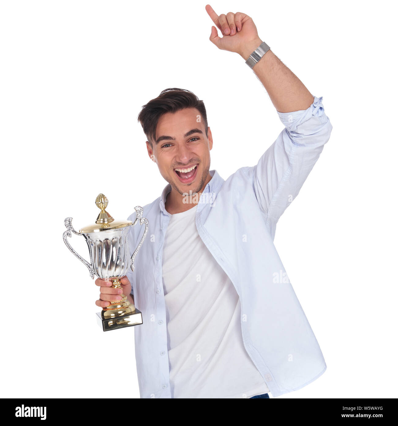 excited young casual man holding trophy cup is celebrating success on ...