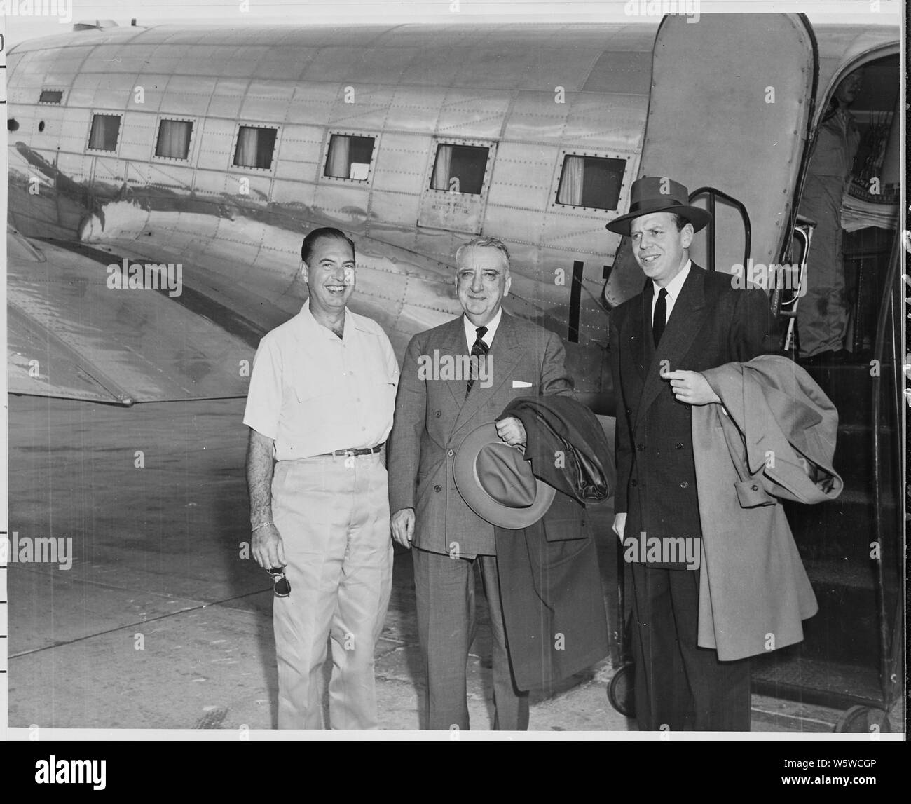 Photograph of Rear Admiral Robert Dennison, Naval Aide to the President, with Chief Justice Fred Vinson and Clark Clifford, ex-Special Counsel to the President (right), who have arrived at Boca Chica airport to join President Truman's vacation party at Key West, Florida. Stock Photo