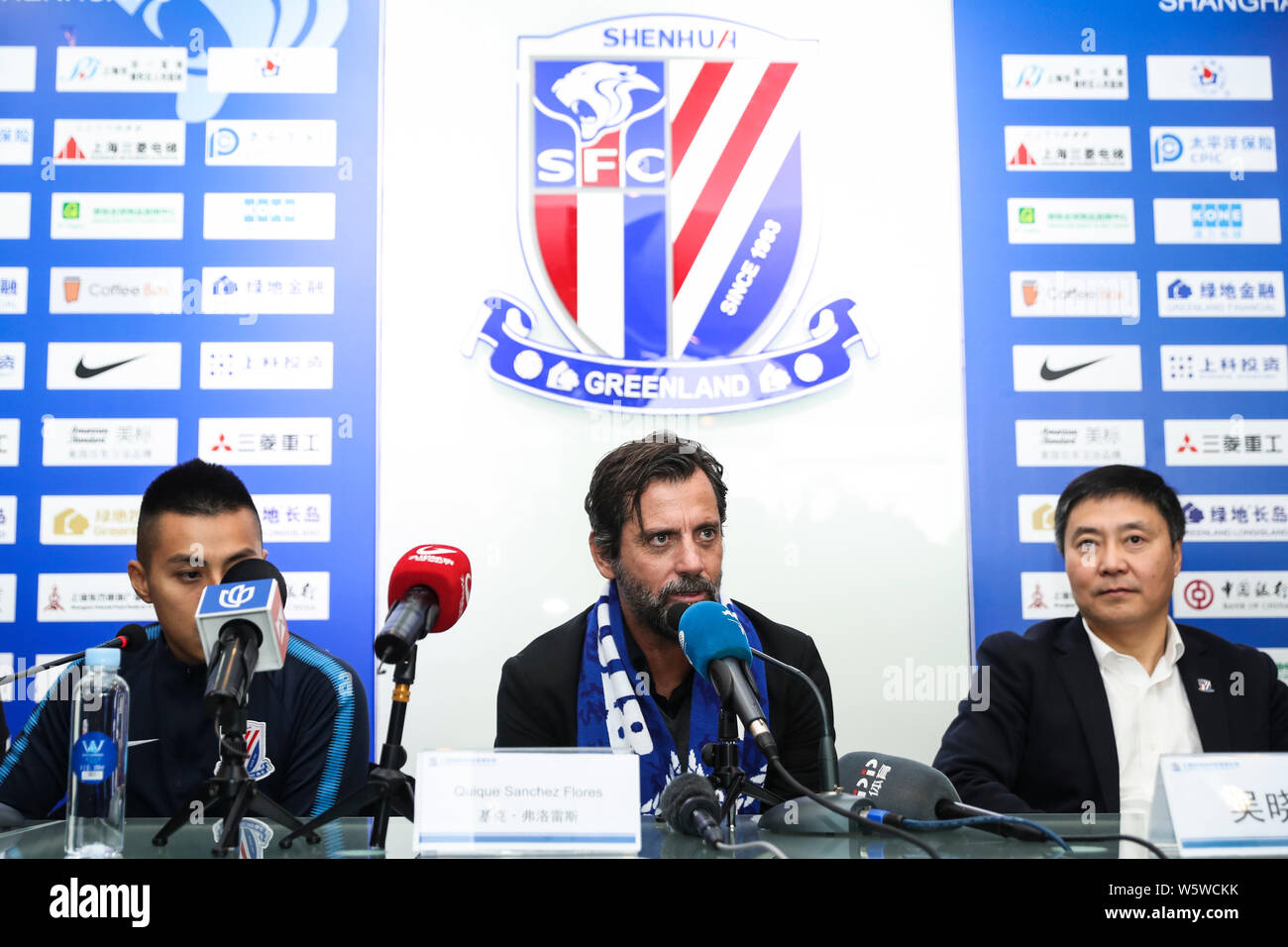 Spanish football manager Quique Sanchez Flores, center, the new head coach of Shanghai Greenland Shenhua FC, attends a press conference in Shanghai, C Stock Photo