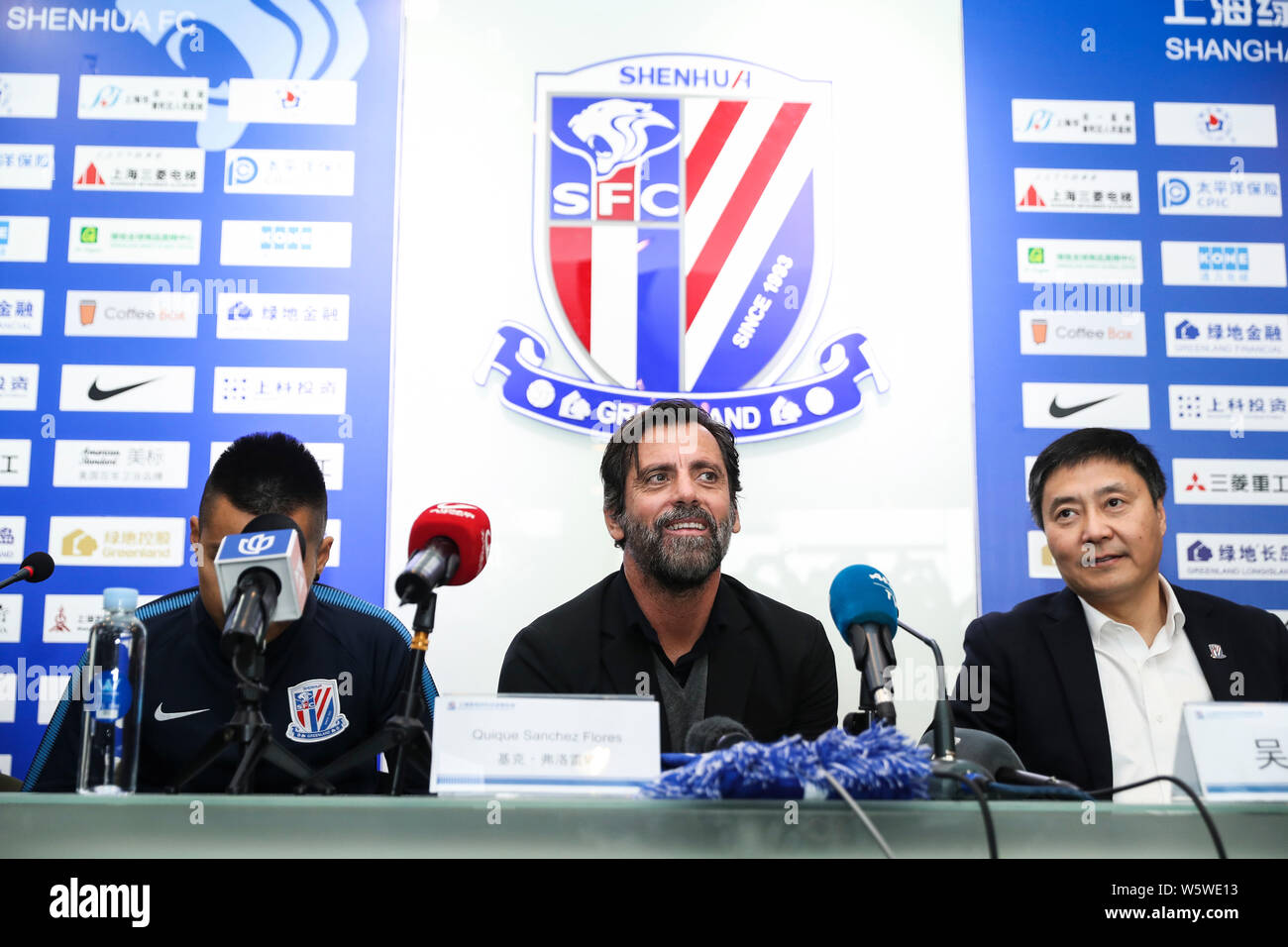 Spanish football manager Quique Sanchez Flores, center, the new head coach of Shanghai Greenland Shenhua FC, attends a press conference in Shanghai, C Stock Photo