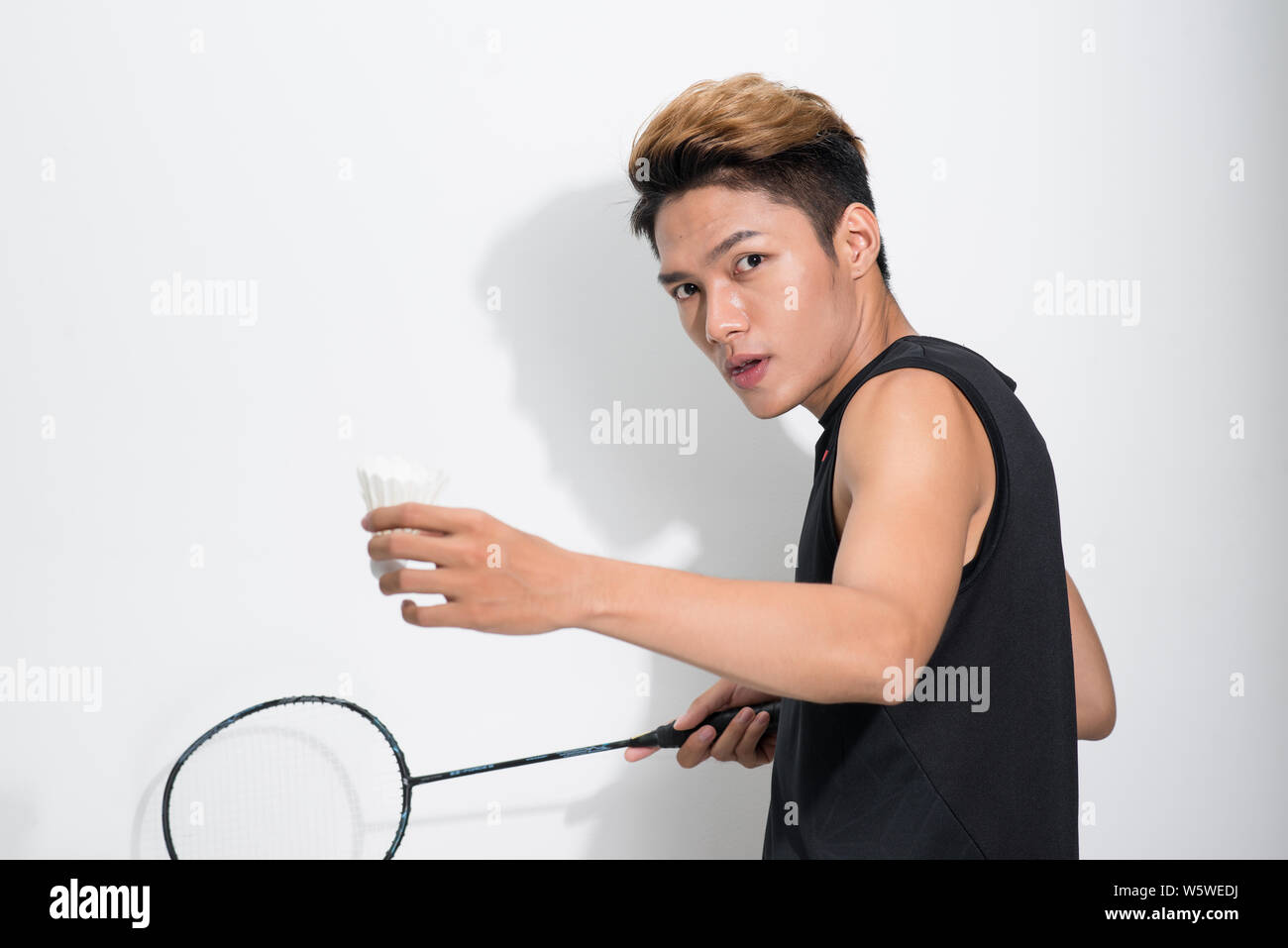 Asian male badminton player on white background. Stock Photo