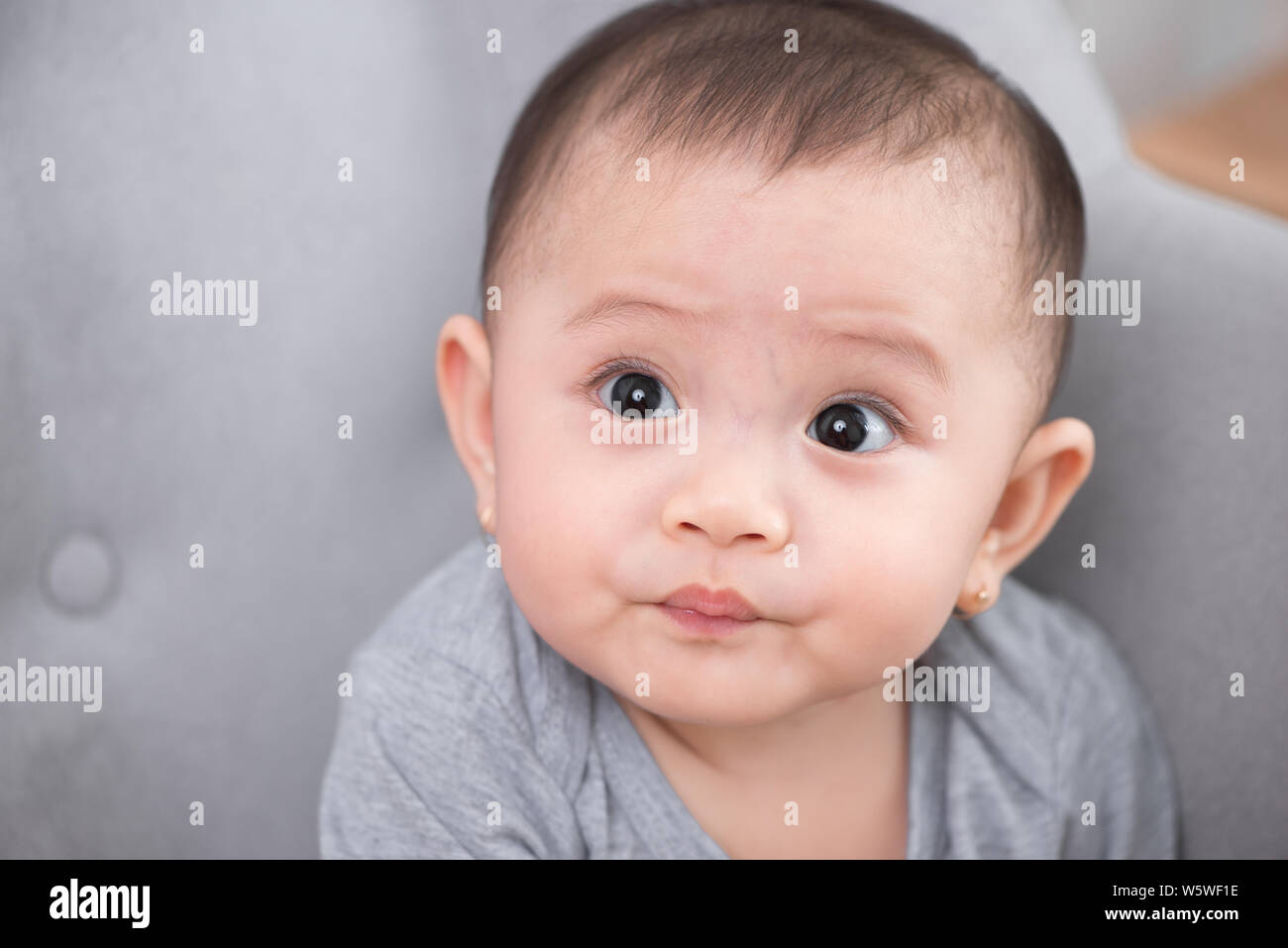 Image of sweet baby girl, closeup portrait of cute 8 month-old smiling girl, toddler. Stock Photo