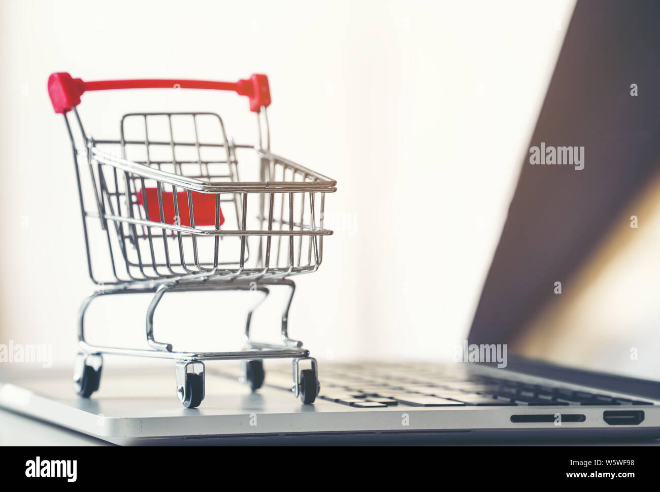 shopping cart with laptop on the desk, online shopping concept Stock