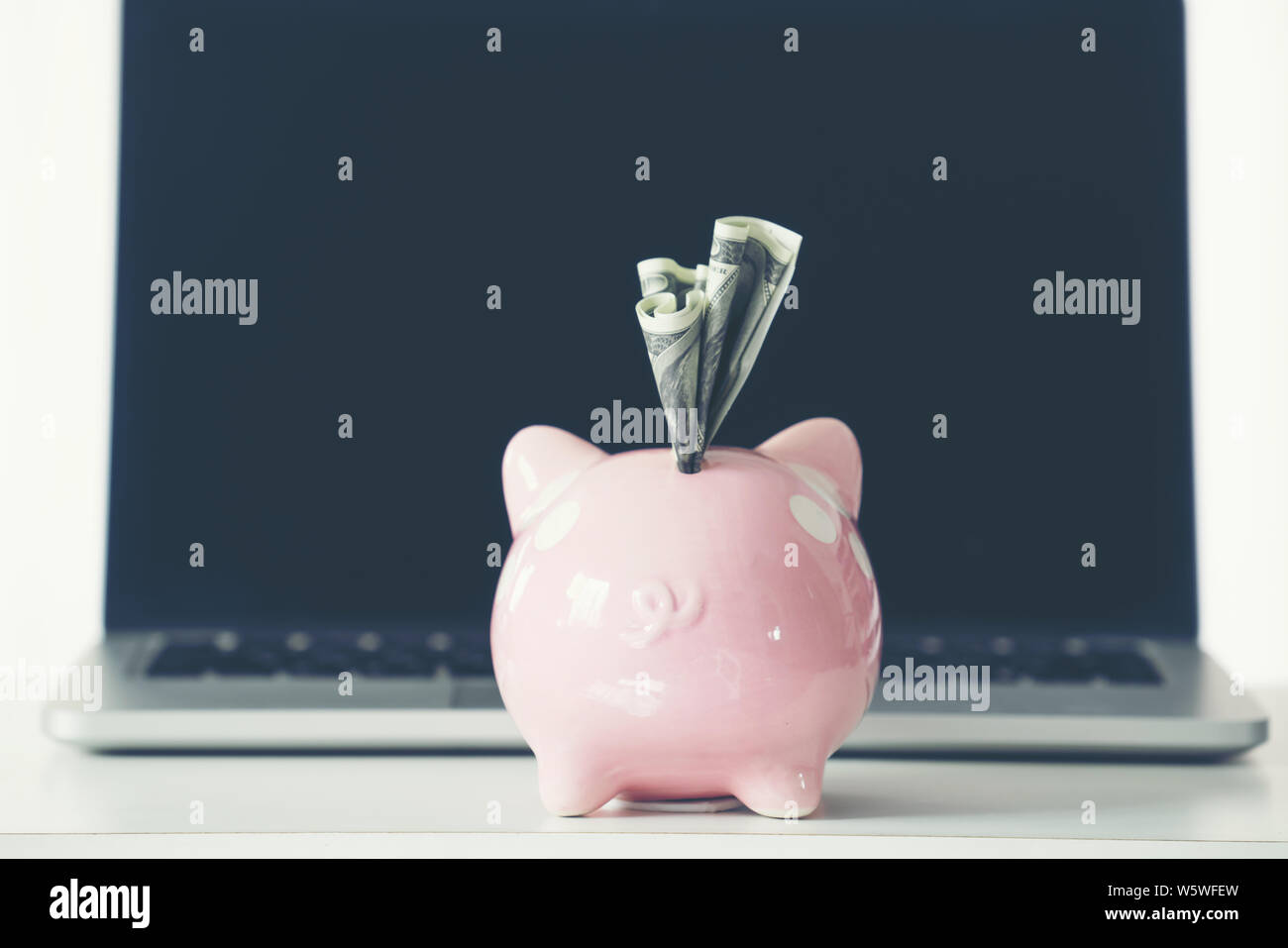 piggy bank with laptop on the desk, online shopping concept Stock Photo