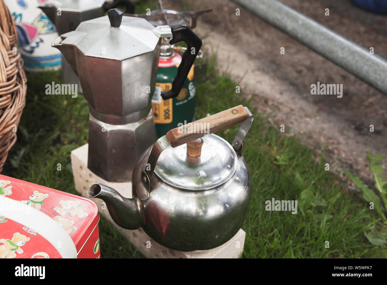 Italian moka pot coffee maker stands near small kettle on the grass Stock Photo
