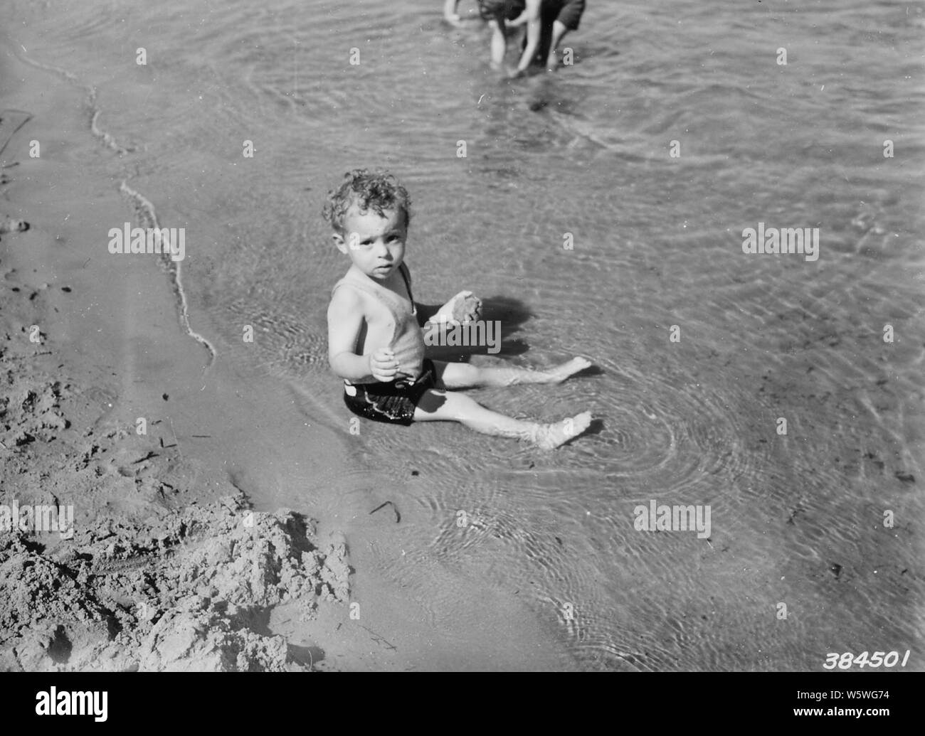 Photograph of Wayne Smith; Scope and content:  Original caption: Wayne Smith, aged 2, of Dafter, Michigan playing in the sand, Brevort Lake swimming beach. Stock Photo