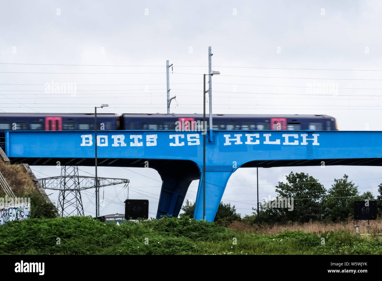 Bristol, UK, 30th July 2019. Work took place last week to overpaint negative Boris graffiti on the Railway bridge over the M4 between junctions 19 and 20 westbound. It was completed ahead of Boris Johnson becoming UK Prime Minister. Fresh graffiti has now been painted. A local resident confirmed it was only a 'day or so old'. Credit: Mr Standfast / Alamy Live News (Helch may refer to a graffiti artist) Stock Photo