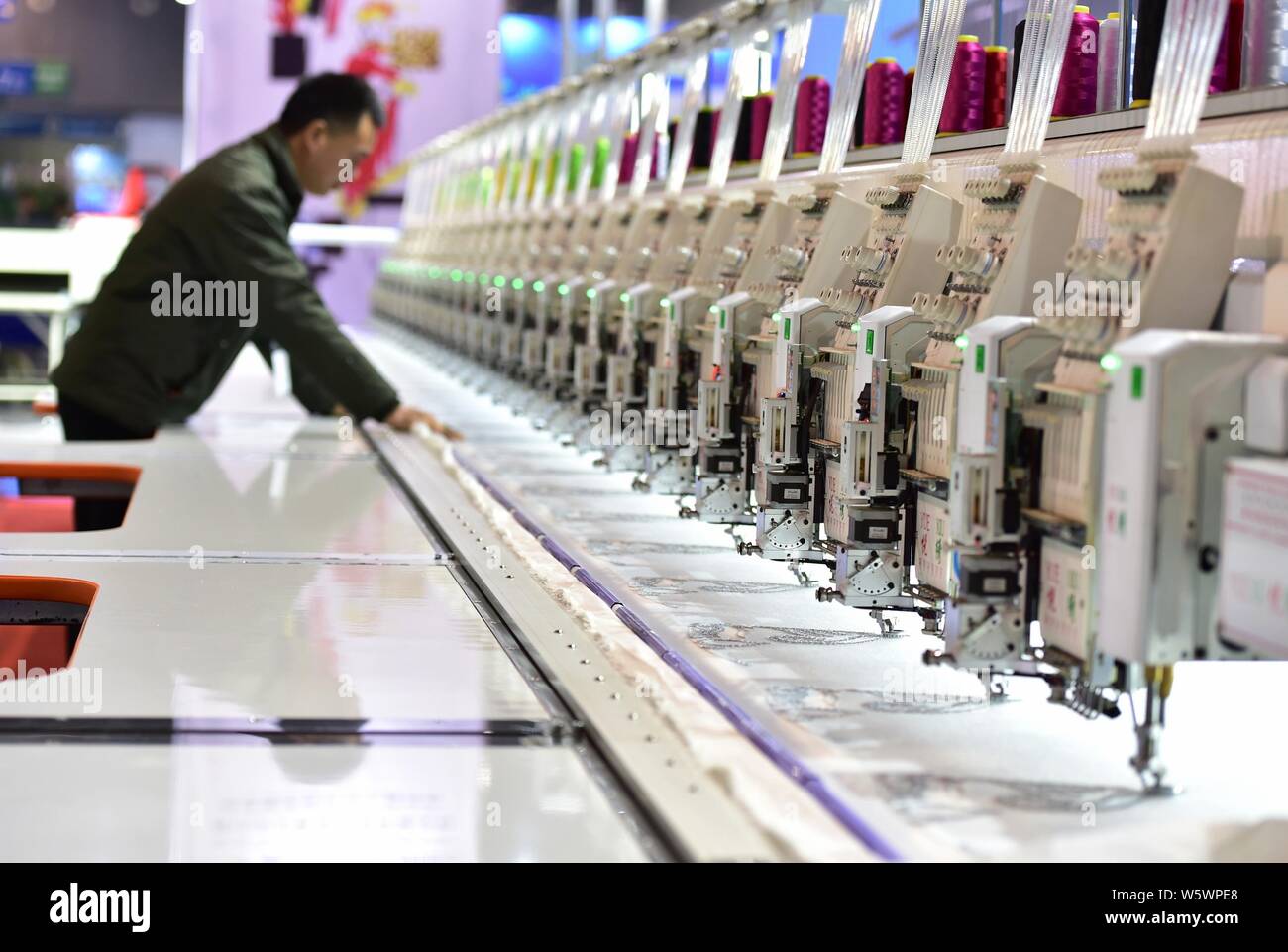 Embroidery equipments are on display during the 5th China Yiwu International Manufacturing Equipment Expo in Yiwu city, Jinhua city, east China's Zhej Stock Photo