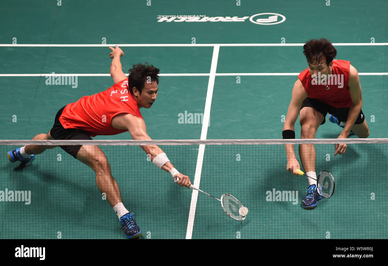 Ko Sunghyun and Shin Baekcheol of South Korea compete against Kim Gi