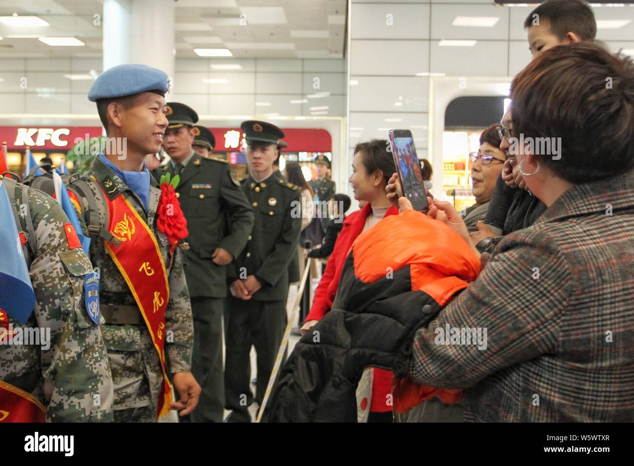 Chinese peacekeepers attend a ceremony after returning to China