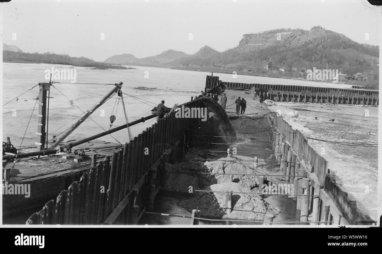 Photograph with caption Pumping fill into cofferdam with dredge pump, Lock and Dam 6. Stock Photo