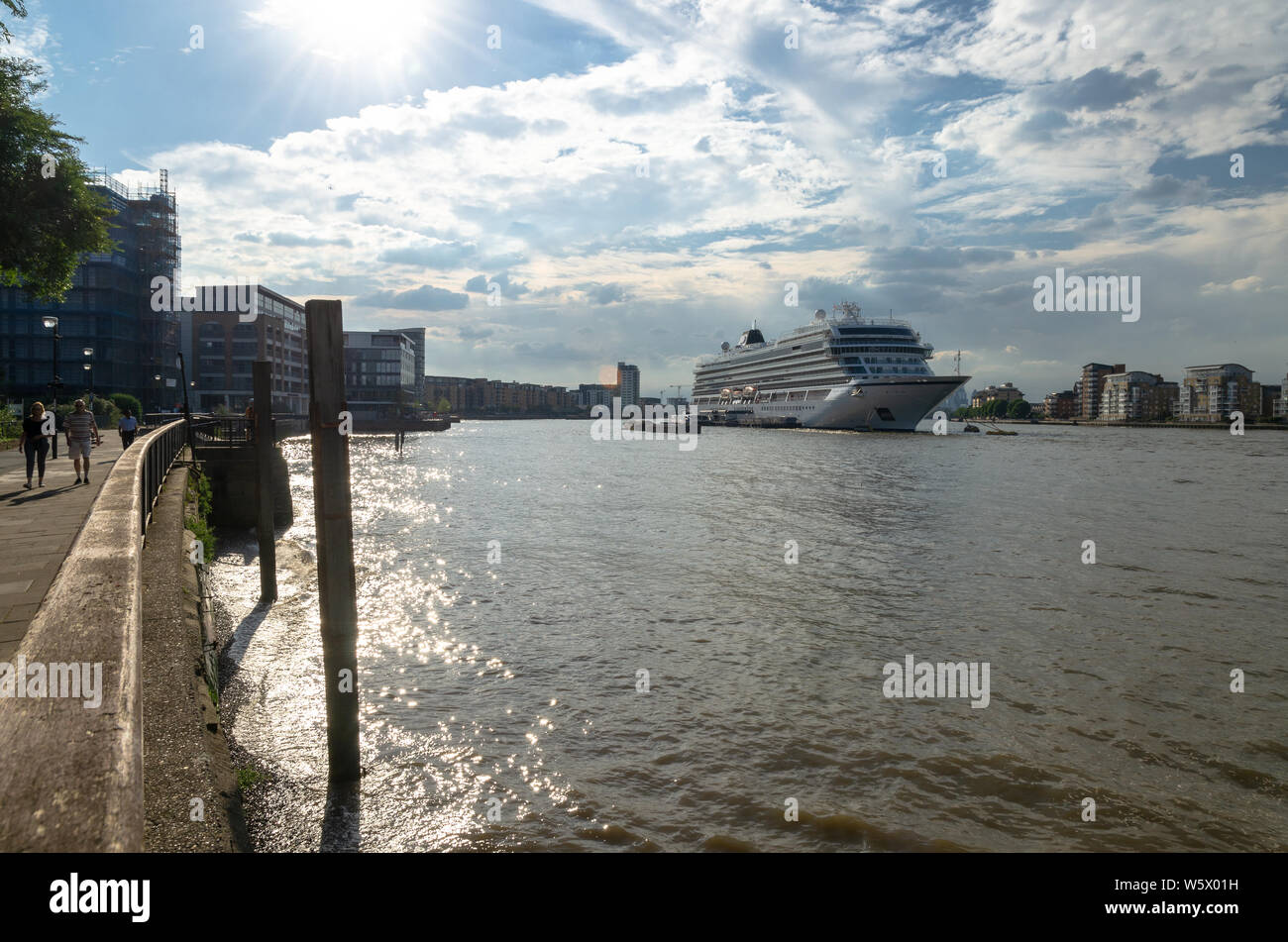Tourists walking by the River Thames by the moored Viking Sky cruise ship at Greenwich, London Stock Photo