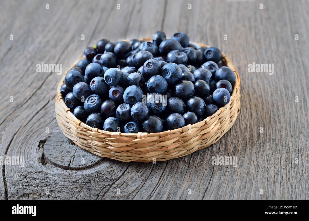 Fresh ripe blueberries on wooden table, close up Stock Photo