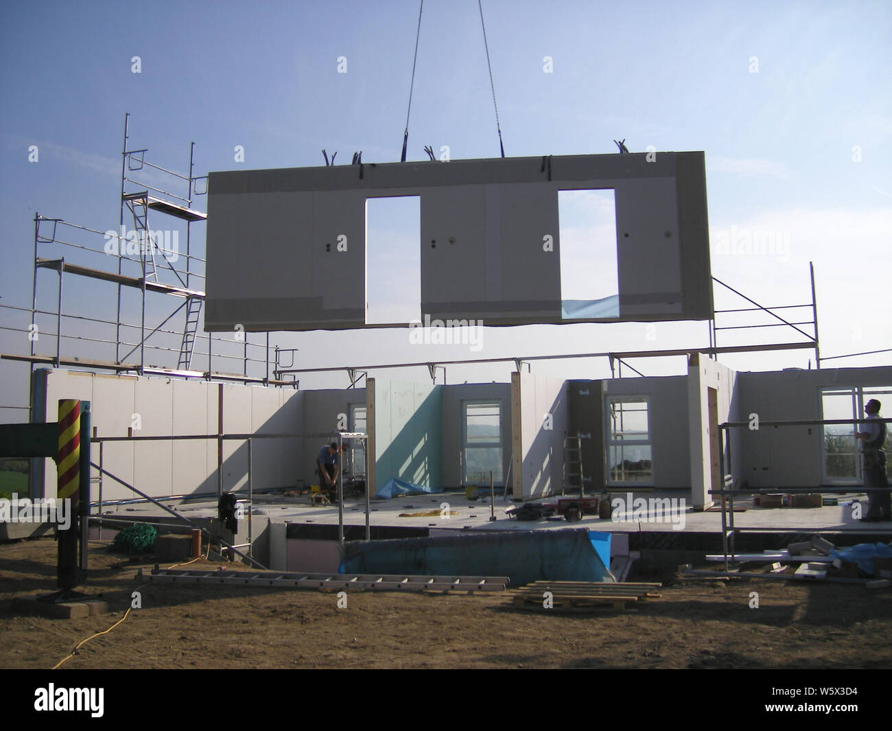 crane lifting a part of a prefab house Stock Photo Alamy