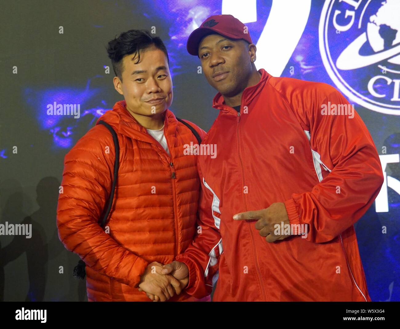 Jamaican-American IFBB professional bodybuilder Shawn Rhoden, right, poses for photos with a fan during a bodybuilding competition in Shanghai, China, Stock Photo