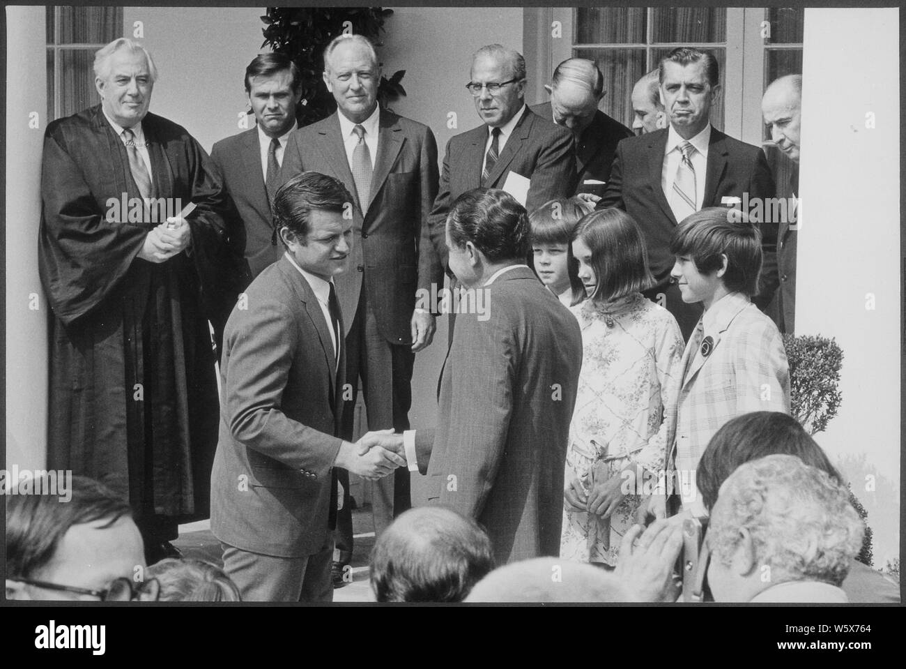 President Nixon shaking hands with Senator Ted Kennedy at the White House swearing-in ceremony for Secretary Elliott l. Richardson and Counsellor Robert H. Finch; Scope and content:  Pictured: Senator Ted Kennedy, President Richard Nixon. Subject: Staff with President- Group. Stock Photo