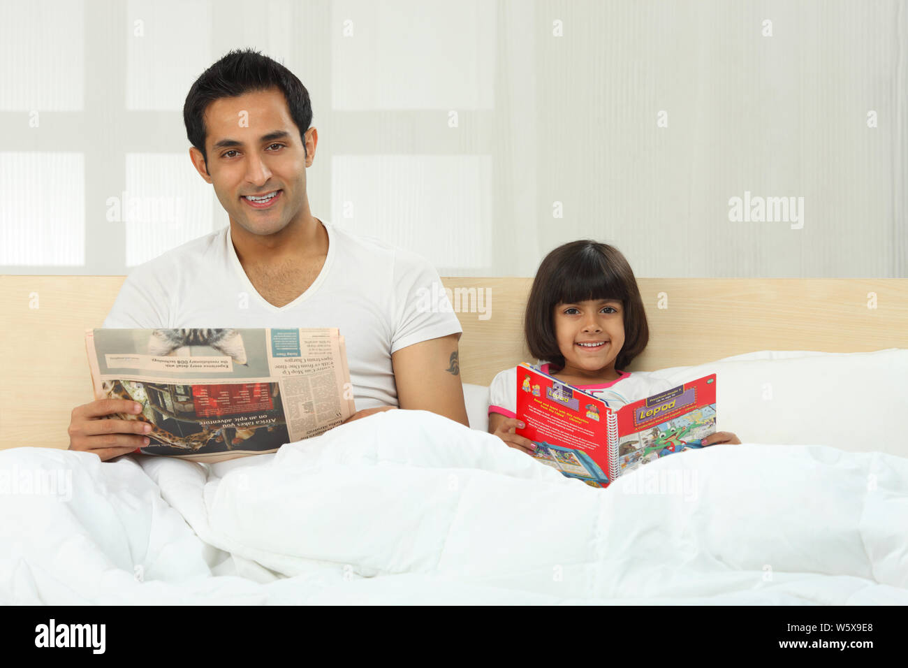 Indian girl reading book bed hi-res stock photography and images - Alamy
