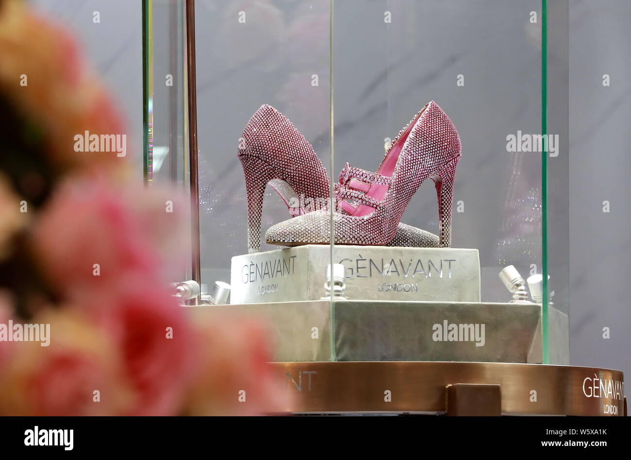 A pair of luxury high heel shoes named 'Chun Can' and inlayed with 10,000 rare pink diamonds is on display at the stand of luxury company Genavant dur Stock Photo