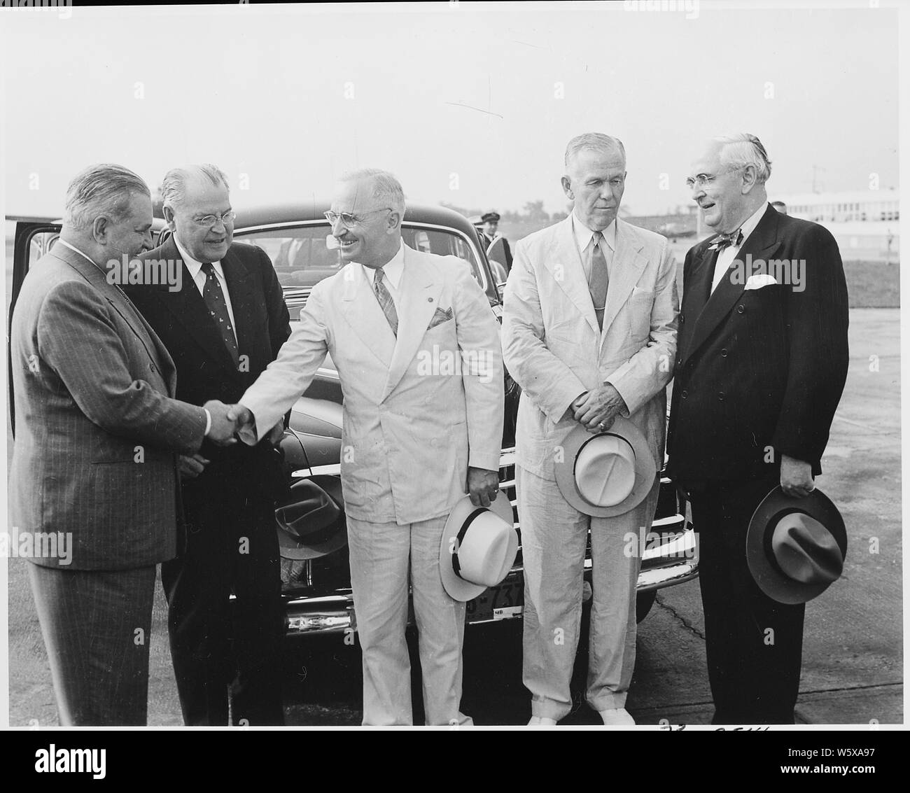 President Truman sees off Secretary of State George Marshall and two delegates at National Airport in Washington, D. C. as they leave for Brazil to attend the Rio de Janeiro Conference of Foreign Ministers. L to R: Brazilian Ambassador Carlos Martins, Warren Austin, U. S. Representative to the United Nations, President Truman, Secretary Marshall, and Sen. Arthur Vandenberg. Stock Photo