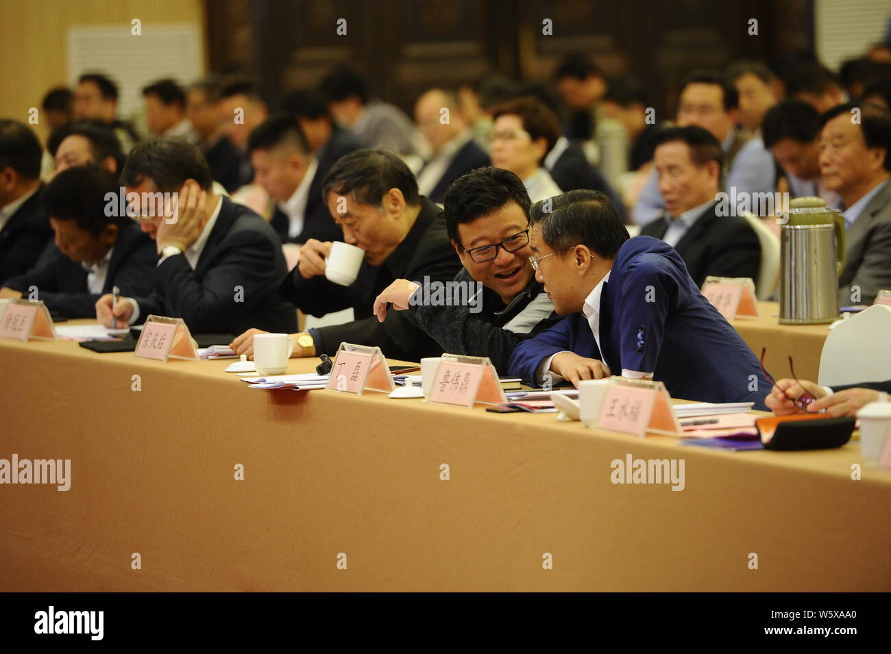 William Ding or Ding Lei, left, CEO of Netease (163.com), talks with Lu Weiding, Chief Executive Officer and President of Wanxiang Group, during the H Stock Photo