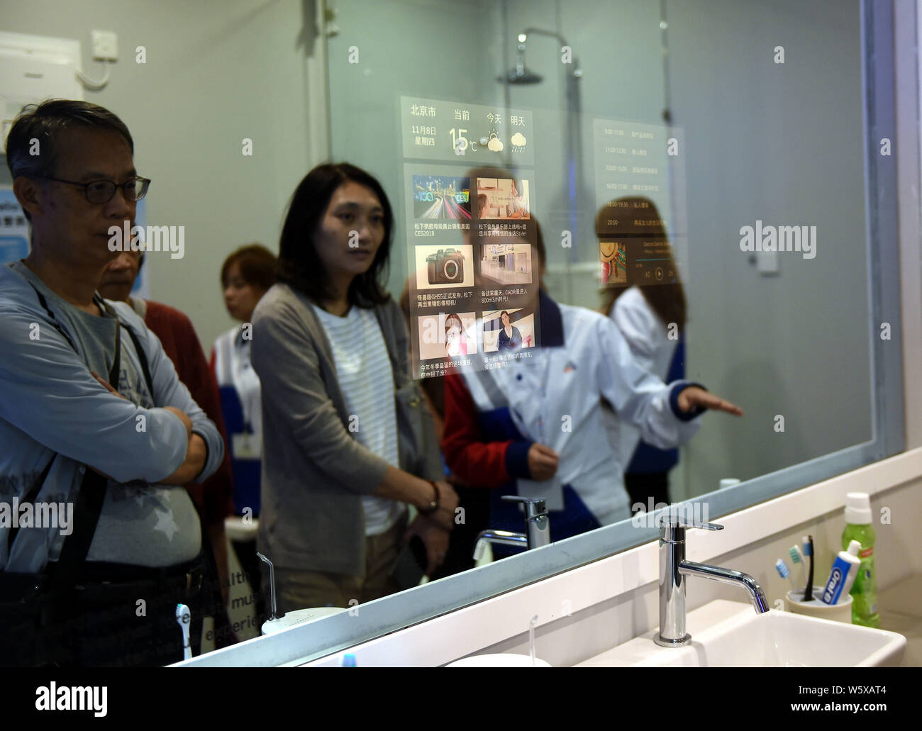 Visitors try out magic mirror during the Future of Living Expo held by