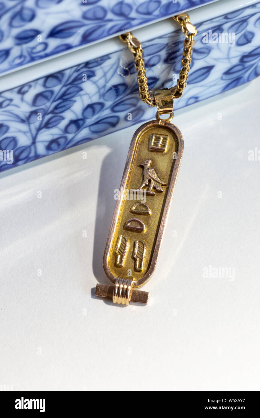 Gold Eqyptian Cartouche Pendant with ceramic jewelry box Stock Photo