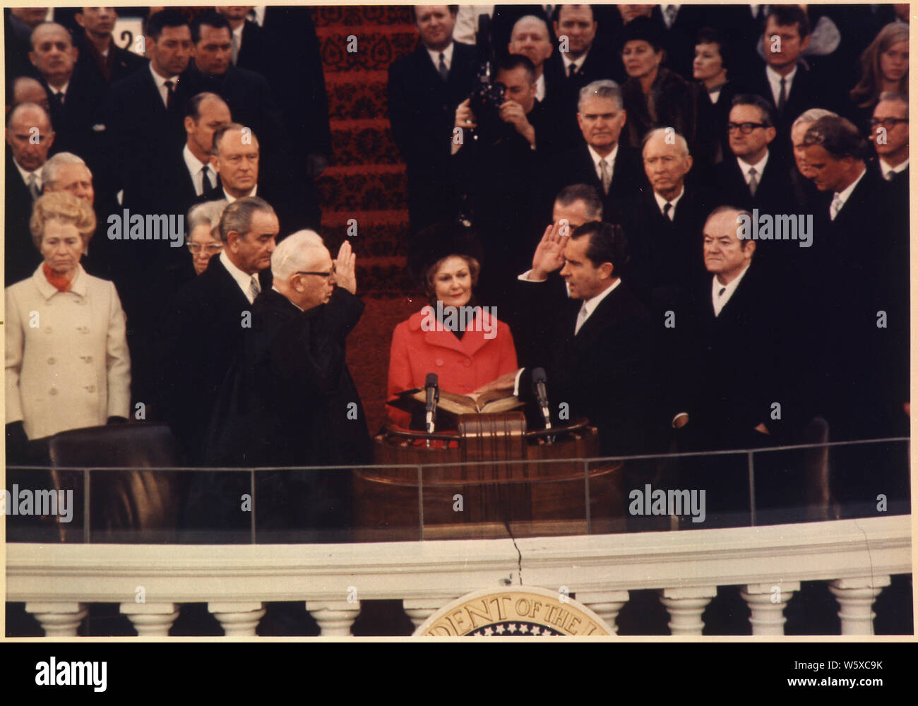 President-elect Nixon taking the oath of office as President of the United States; Scope and content:  Pictured: Lyndon Baines Johnson, Everett M. Dirksen, Thelma Ryan (Pat) Nixon, Richard M. Nixon, Hubert H. Humphrey. Subject: Inauguration - 1969. Stock Photo