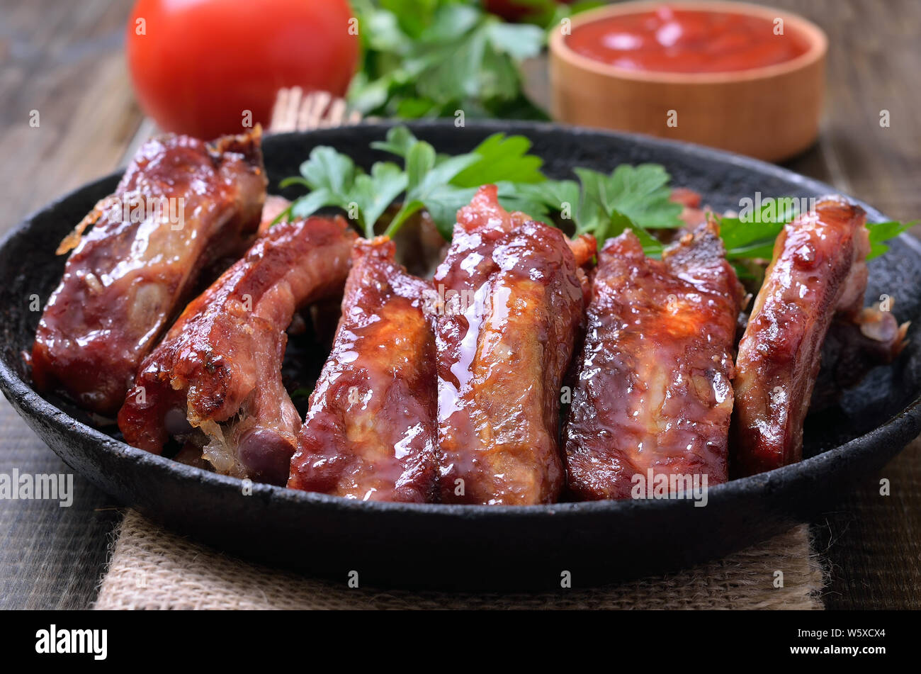 Grilled pork ribs in frying pan, close up view Stock Photo
