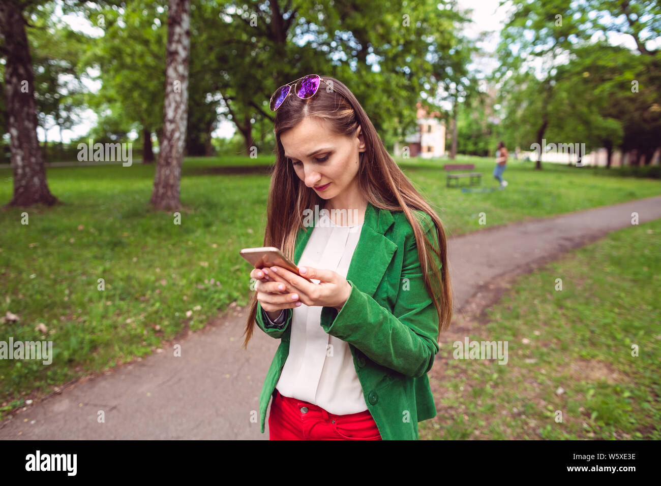 Young woman receiving a disturbing message on her phone Stock Photo