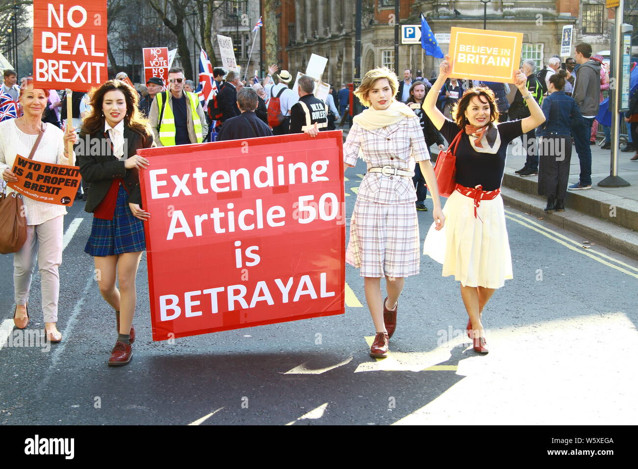 EXTENDING ARTICLE 50 IS BETRAYAL SIGN BEING CARRIED THROUGH THE STREETS OF WESTMINSTER AT A PUBLIC DEMONSTRATION. OTHER SIGNS HELD UP INCLUDE NO DEAL BREXIT , NO TO 2ND REFERENDUM AND BELIEVE IN BRITAIN. DEVIDED NATION. DEVIDED BRITAIN. STREET LIFE. PROTESTS. FREEDOM OF SPEECH. RUSSELL MOORE PORTFOLIO PAGE. Stock Photo