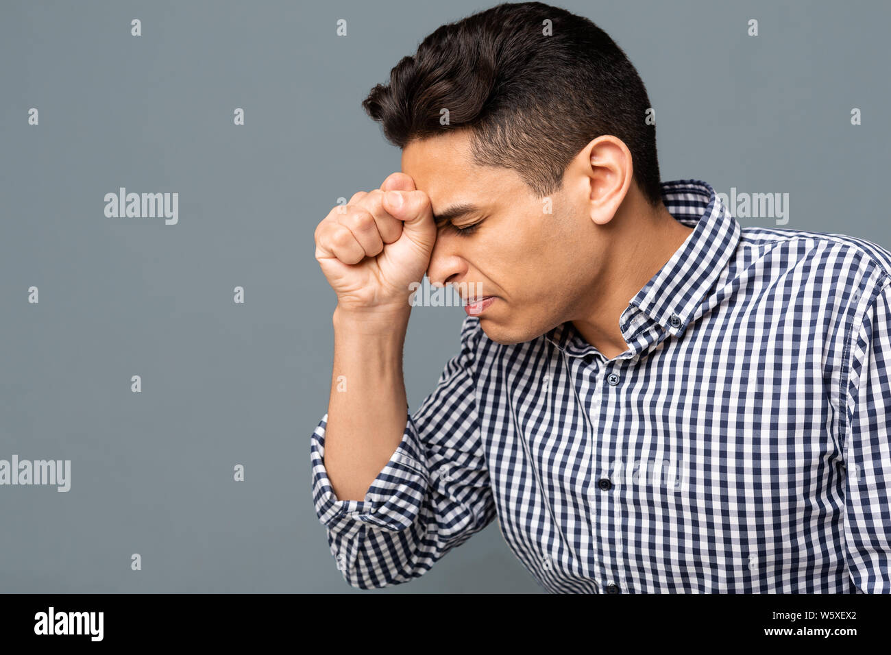Upset Arab Man Pressing Clenched Fist To Forehead, Copy Space Stock Photo